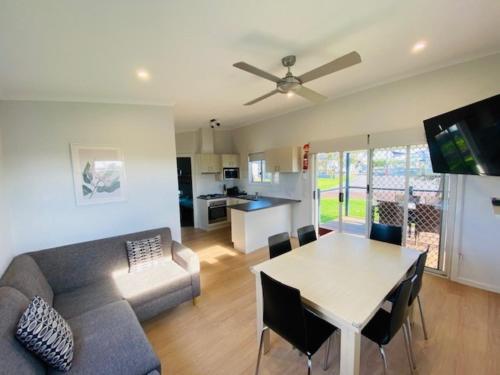 a living room with a couch and a table at BIG4 Port Fairy Holiday Park in Port Fairy