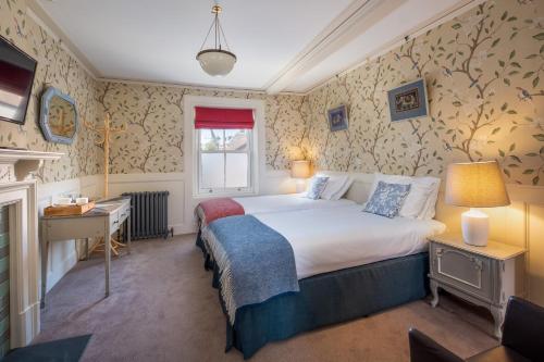 a hotel room with a bed and a desk at One Holyrood Hotel & Cafe in Newport