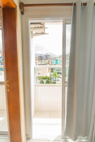an open window with a view of a balcony at UPG Hotel in Ubatuba
