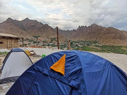 a blue and orange tent with mountains in the background at Khachats Toun Heritage in Meghri