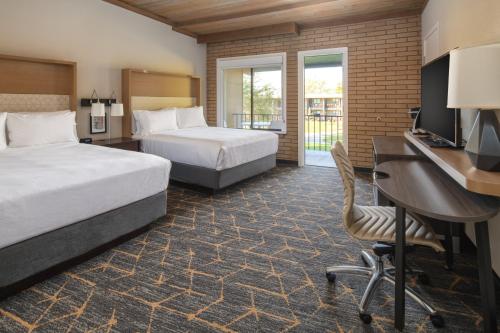 a hotel room with two beds and a desk at Holiday Inn Richland on the River by IHG in Richland