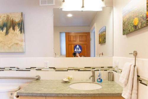 a bathroom with a sink and a large mirror at 90 San Luis Street Unit B in Avila Beach