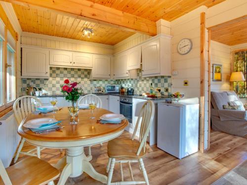 a kitchen with a table and chairs in a kitchen at Apple Tree Lodge in Swarland
