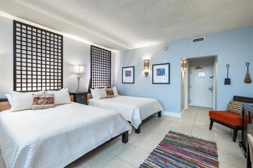 a hotel room with two beds and a chair at The Artful Nook in Ruskin