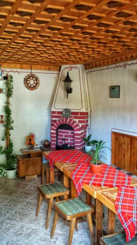 a living room with a table and a fireplace at Mechta Guest House in Koprivshtitsa