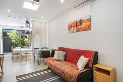 a living room with a couch and a table at BRID243FL-G - Converted Garage on Foss - King Bed in Sydney