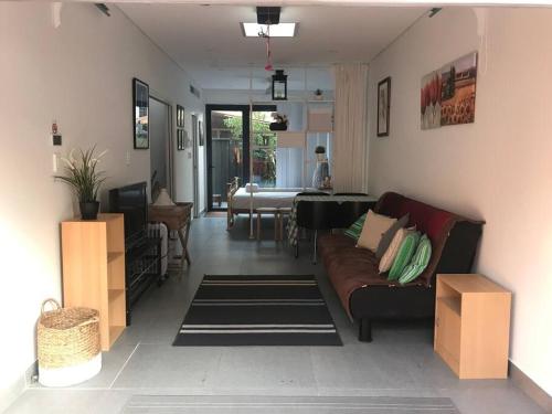 a living room with a couch and a table at BRID243FL-G - Converted Garage on Foss - King Bed in Sydney