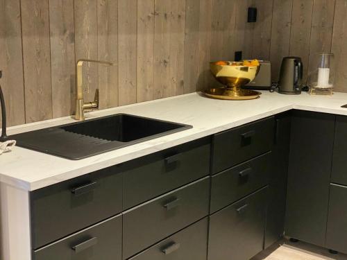 a kitchen with a sink and a counter top at Villa Solsiden Geilo in Geilo
