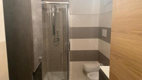 a bathroom with a shower and a toilet at La Maison in Mondragone