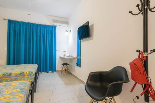 a room with a bed and a chair and a table at Studio Timotheos in Marathias