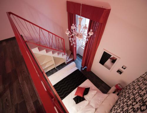 a bedroom with a red bed and a red dresser at Bed&Breakfast Andio in Dubrovnik