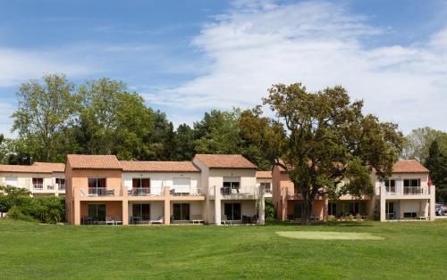 an exterior view of a building with a yard at SOWELL RESIDENCES Les Perles du Golfe de Saint-Tropez in Grimaud