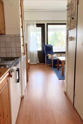 a kitchen with a counter and a dining room with a table at Motel Patalahti in Jämsä