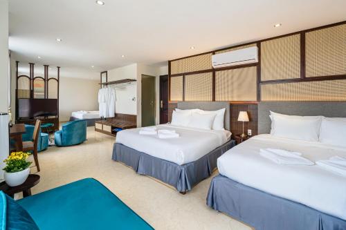 a bedroom with two beds and a living room at Aquatel Vung Tau in Vung Tau