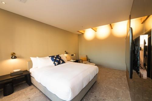 Postel nebo postele na pokoji v ubytování Hotel Museo Cheongju