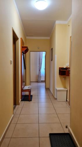 a hallway with a large tile floor and a room at Hotel La Passionaria in Mariánské Lázně