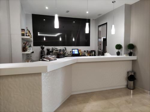 a kitchen with a large white counter top at Hotel Ciudad de Navalcarnero in Navalcarnero