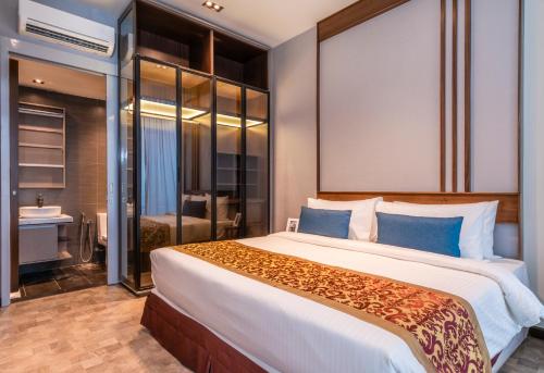 a bedroom with a large bed and a bathroom at Expressionz Professional Suites by MyKey in Kuala Lumpur
