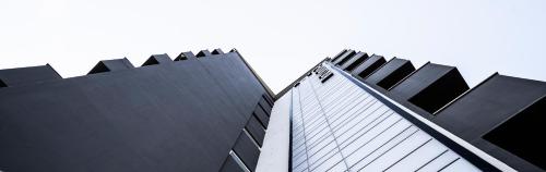 a close up of two tall black buildings at Rotonda Hotel in Thessaloniki