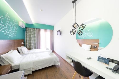 a hotel room with a bed and a mirror at Rotonda Hotel in Thessaloniki