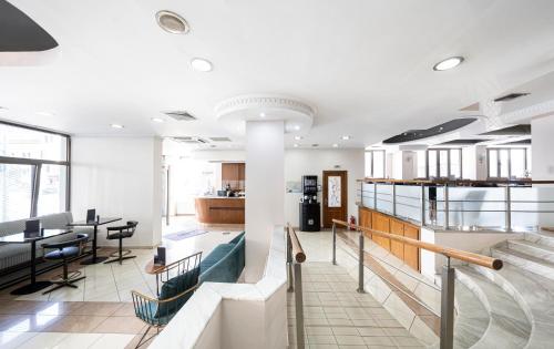 a lobby of a building with a table and chairs at Rotonda Hotel in Thessaloniki