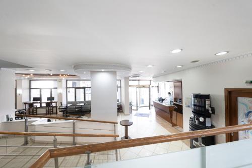 a large room with white walls and a staircase at Rotonda Hotel in Thessaloniki