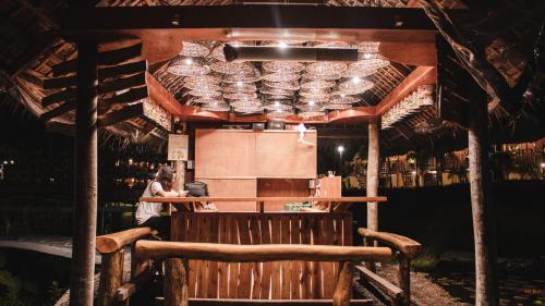 a woman standing at a counter in a bar at Your Brothers House Tribal Village in Legazpi