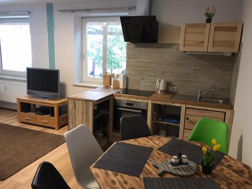 a kitchen and dining room with a table and chairs at Ferienwohnung in Burg in Fehmarn