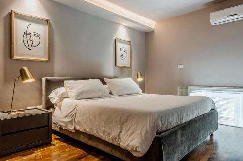 Postel nebo postele na pokoji v ubytování Ferrini Home - Residence 150