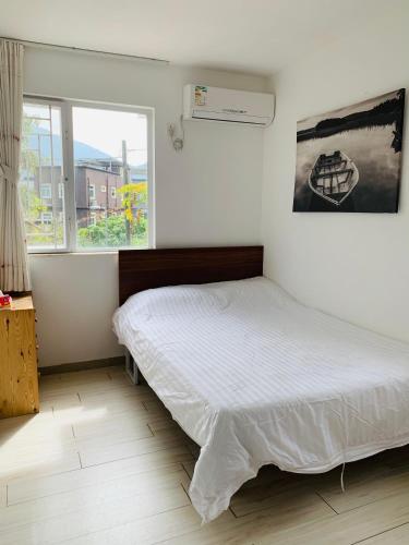 a bedroom with a bed and a window at City Oasis Guesthouse in Hong Kong