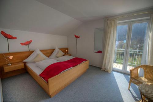 a bedroom with a bed and a large window at Forst´s Landhaus in Riedenburg