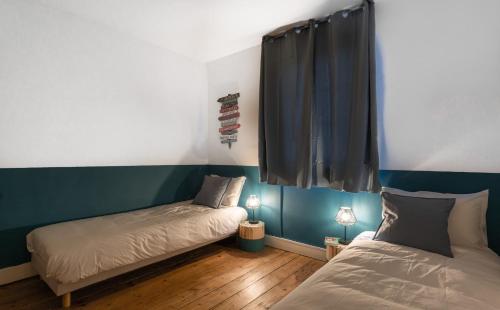 Cama o camas de una habitación en L'Escapade - Maison avec petit jardin - 4 pers