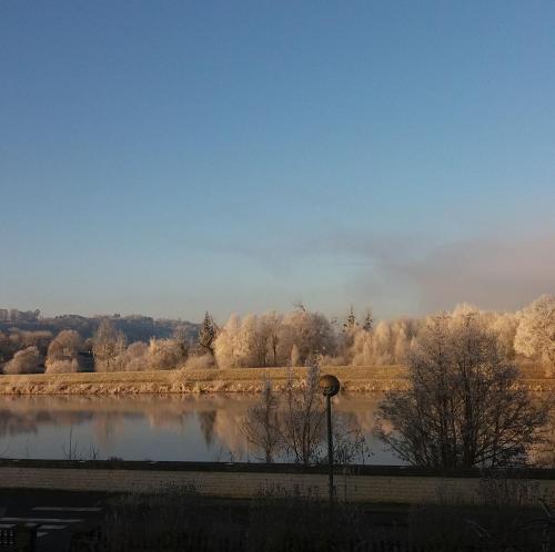 a view of a lake with trees in the background at Le Soleil Couchant/Chambre d'hôtes in Givet