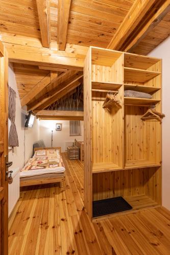 a room with a bunk bed and wooden floors at Chata Rychtářka in Janov nad Nisou
