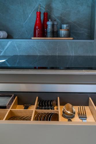 a wooden drawer with utensils in a kitchen at Vip Residences Andorra in El Tarter