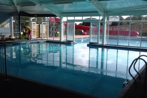 an empty swimming pool with a person in the background at Bayview Brixham in Brixham