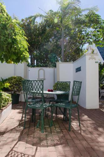 two chairs and a table and a table and chairs at Brighton Lodge - #Solar Energy #No Loadshedding in Port Elizabeth