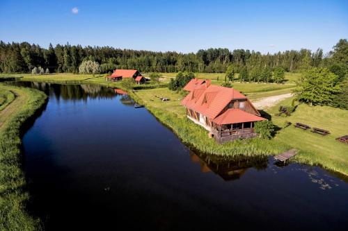 an aerial view of a house on a river at Viesu nams RŪĶĪŠI in Rugāji