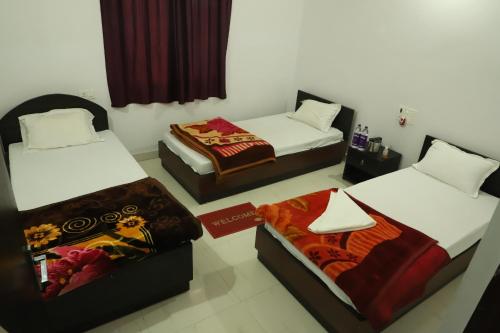 a room with two beds at Gaurav guest house in Bodh Gaya
