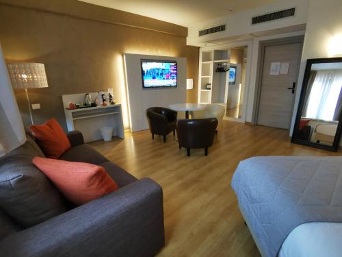 a living room with a couch and a table at Hotel President in Prato