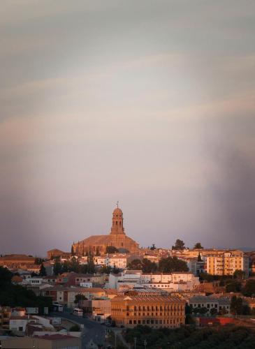 a view of a city with a church on a hill at Hotel Campos de Baeza in Baeza