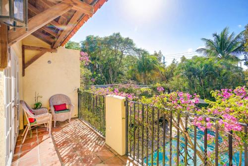 a balcony with a table and chairs and flowers at Grandview Gardens in West Palm Beach