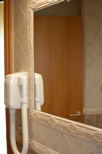a bathroom with a mirror and a urinal in it at Cal Mariner in Port de la Selva