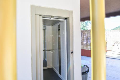 an open door into a room with a glass door at Hotel Palladium Sithonia in Kalamitsi