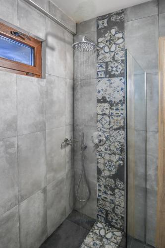 a shower with a glass door in a bathroom at Hotel Palladium Sithonia in Kalamitsi