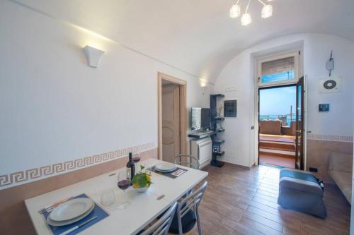 a kitchen and living room with a table and chairs at Holiday House Nuvola in Amalfi Coast in Furore