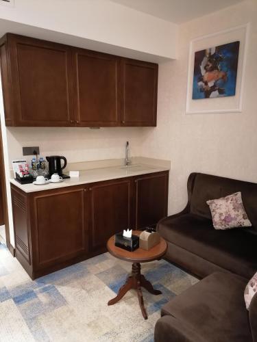 a living room with a couch and a table at Hyksos Hotel in Erbil