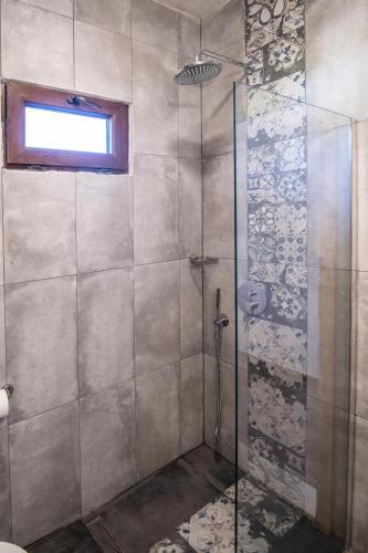 a shower with a glass door in a bathroom at Hotel Palladium Sithonia in Kalamitsi