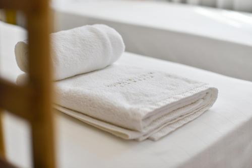 a pile of towels sitting on a bathroom counter at Hotel Palladium Sithonia in Kalamitsi