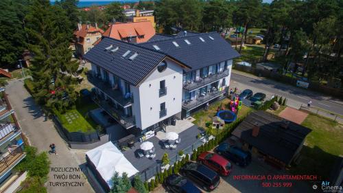 an overhead view of a large white house with a garage at la perla in Krynica Morska